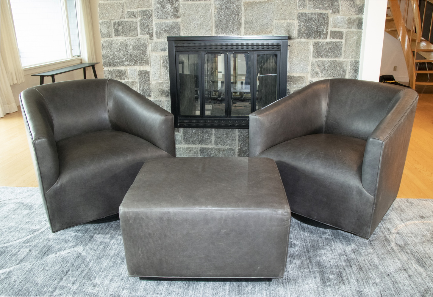 Appraisal: PR OF BLACK LEATHER ARMCHAIRS WITH MATCHING OTTOMAN Two low-backed