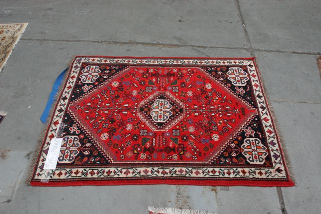 Appraisal: A Caucasian rug with central medallion on red ground decorated