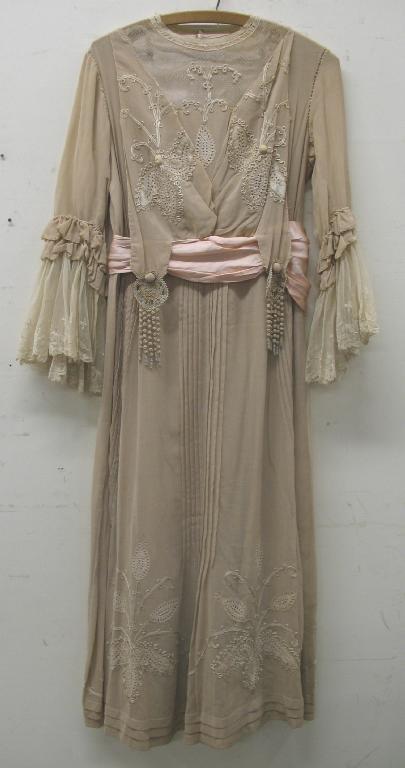 Appraisal: An early th century full length cream dress the skirt