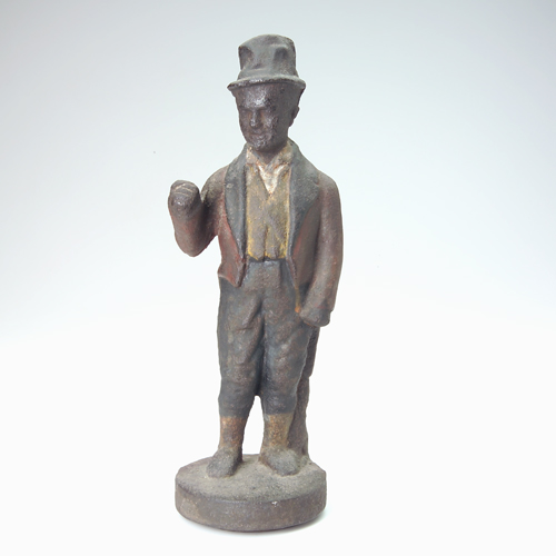 Appraisal: Cast-iron figure of a man dressed in coat and tail