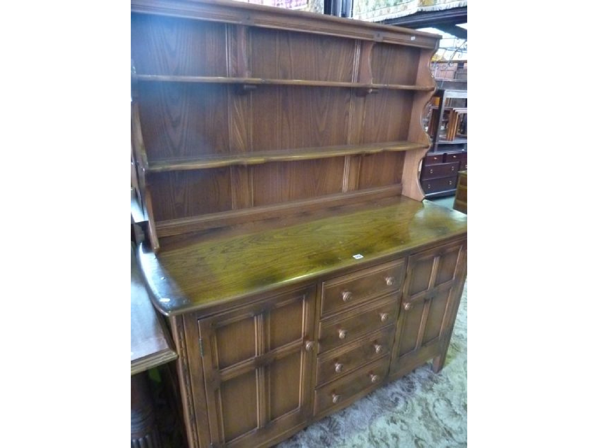 Appraisal: A contemporary Ercol medium elm Golden Dawn dresser the base