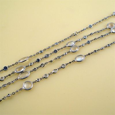 Appraisal: A modern diamond moonstone and sapphire set long chain necklace