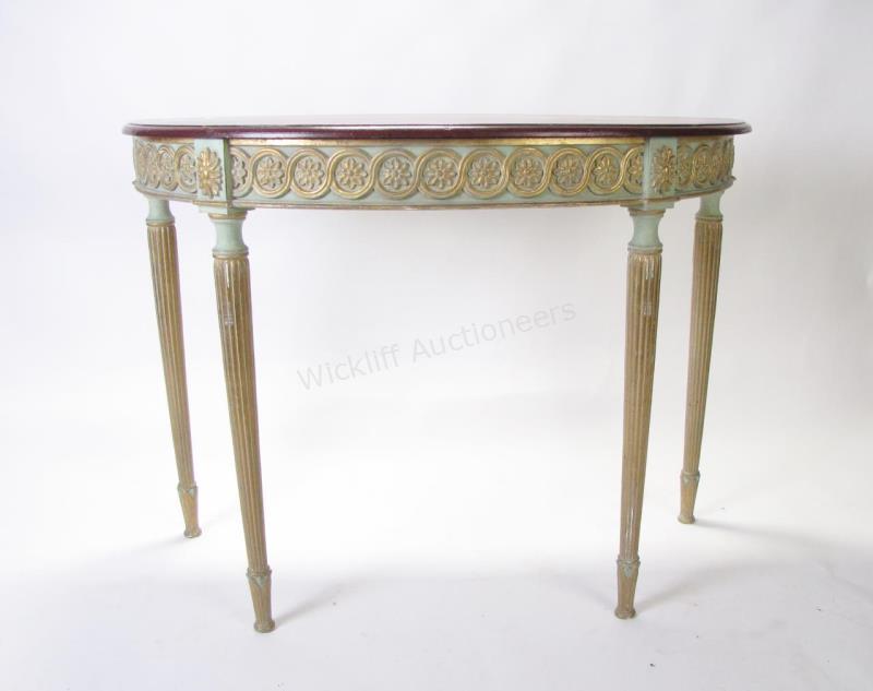 Appraisal: A decorator quality demi-lune console with painted and floral carved