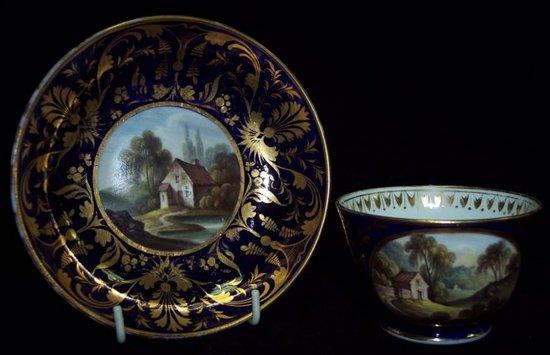 Appraisal: A Derby cup and saucer painted Derbyshire scenes to a