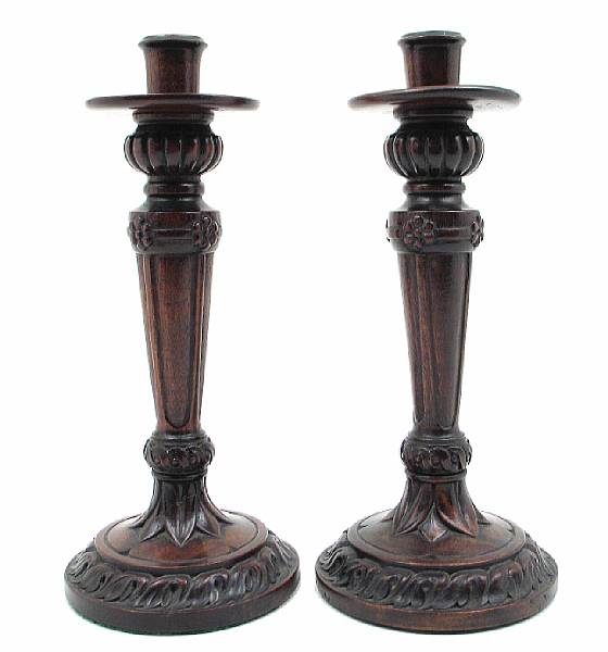 Appraisal: A pair of Neoclassical style carved mahogany candlesticks height in