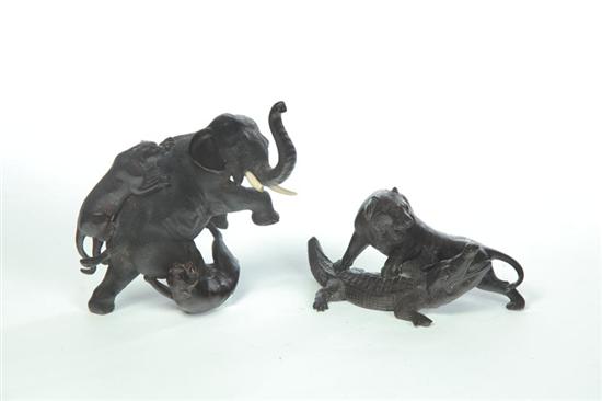 Appraisal: TWO ANIMAL BRONZES Asian th century Figural groups of attacking