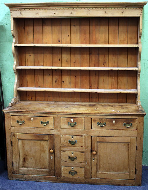 Appraisal: A VICTORIAN PINE DRESSER BASE with associated plate rack above