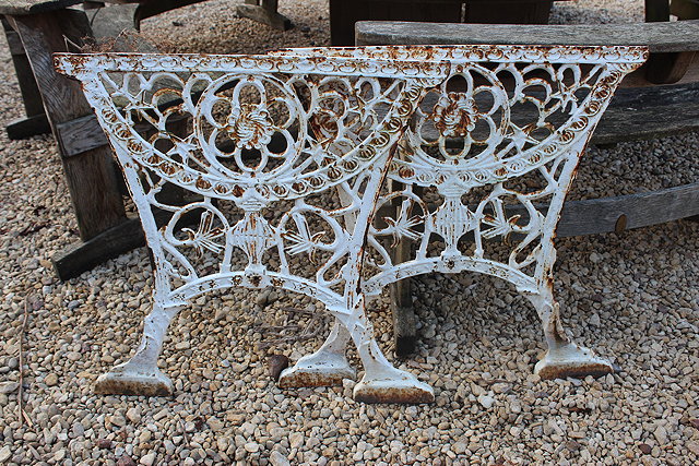 Appraisal: A PAIR OF WHITE PAINTED CAST IRON TABLE ENDS with