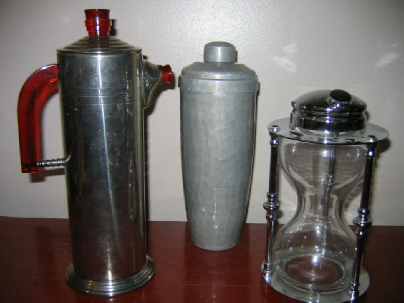 Appraisal: THREE COCKTAIL SHAKERS Hour glass form pewter and Art Deco