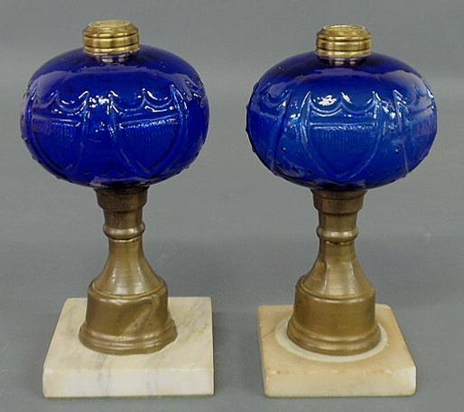 Appraisal: Pair of oil lamps with blue glass fonts and marble