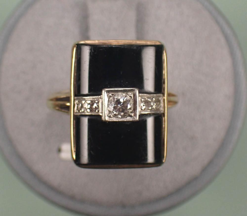 Appraisal: DIAMOND BLACK ONYX AND FOURTEEN KARAT GOLD RING The yellow