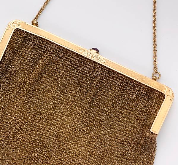 Appraisal: A fourteen karat gold engraved mesh purse accented by a