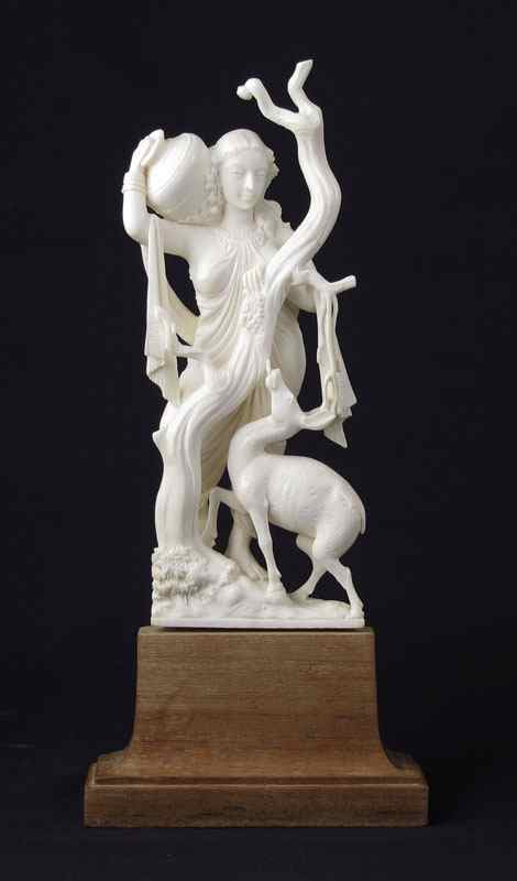 Appraisal: CARVED FIGURAL IVORY WOMAN AND DEER Carved continental ivory in