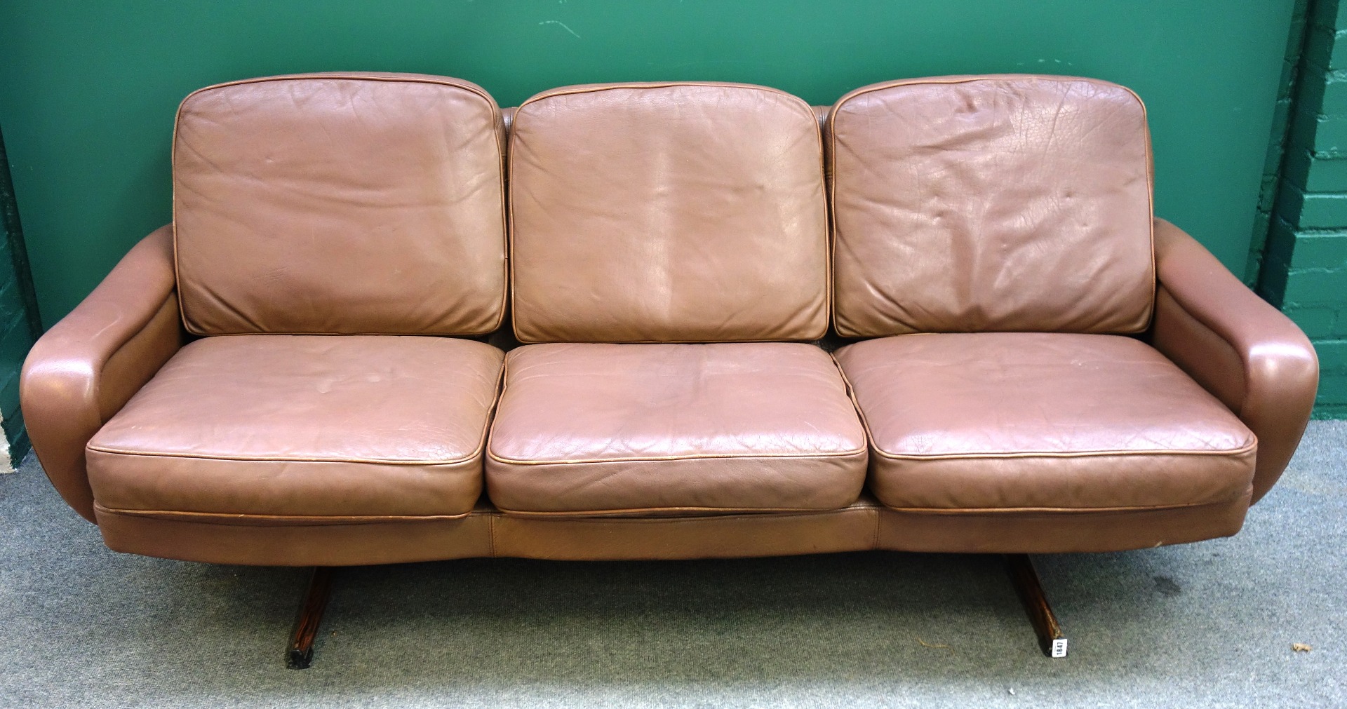 Appraisal: A mid th century brown leather upholstered sofa on faux