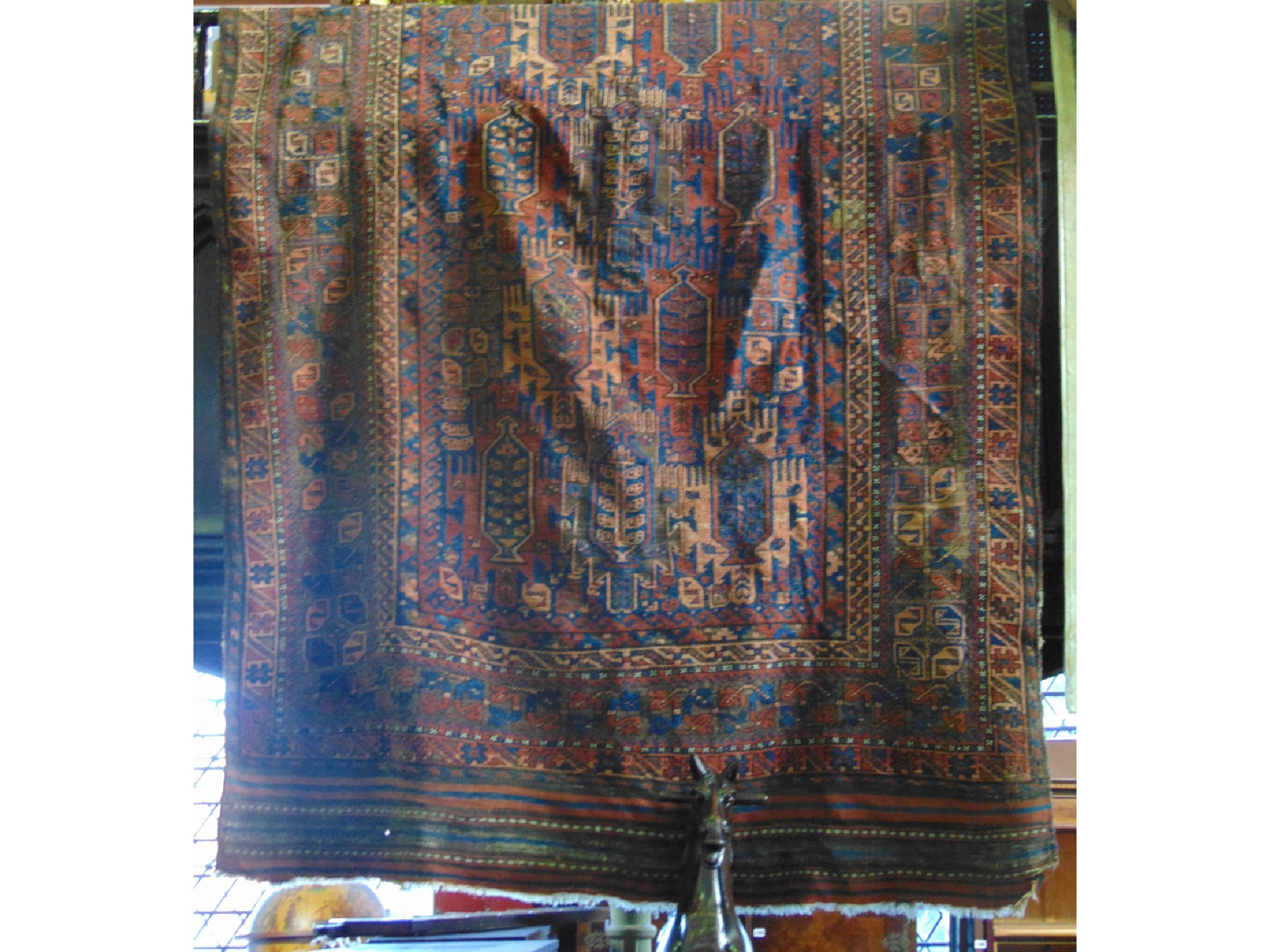 Appraisal: A large old eastern woven wool rug the central field