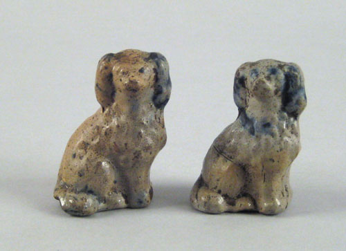 Appraisal: Pair of miniature stoneware spaniels th c with cobalt highlights