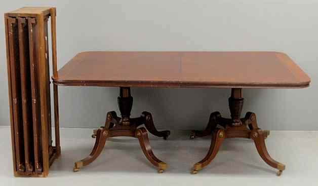 Appraisal: Regency style mahogany dining table with a rectangular cross-banded and