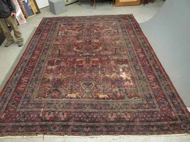 Appraisal: Roomsize Oriental rug with animal figures Worn ' x '