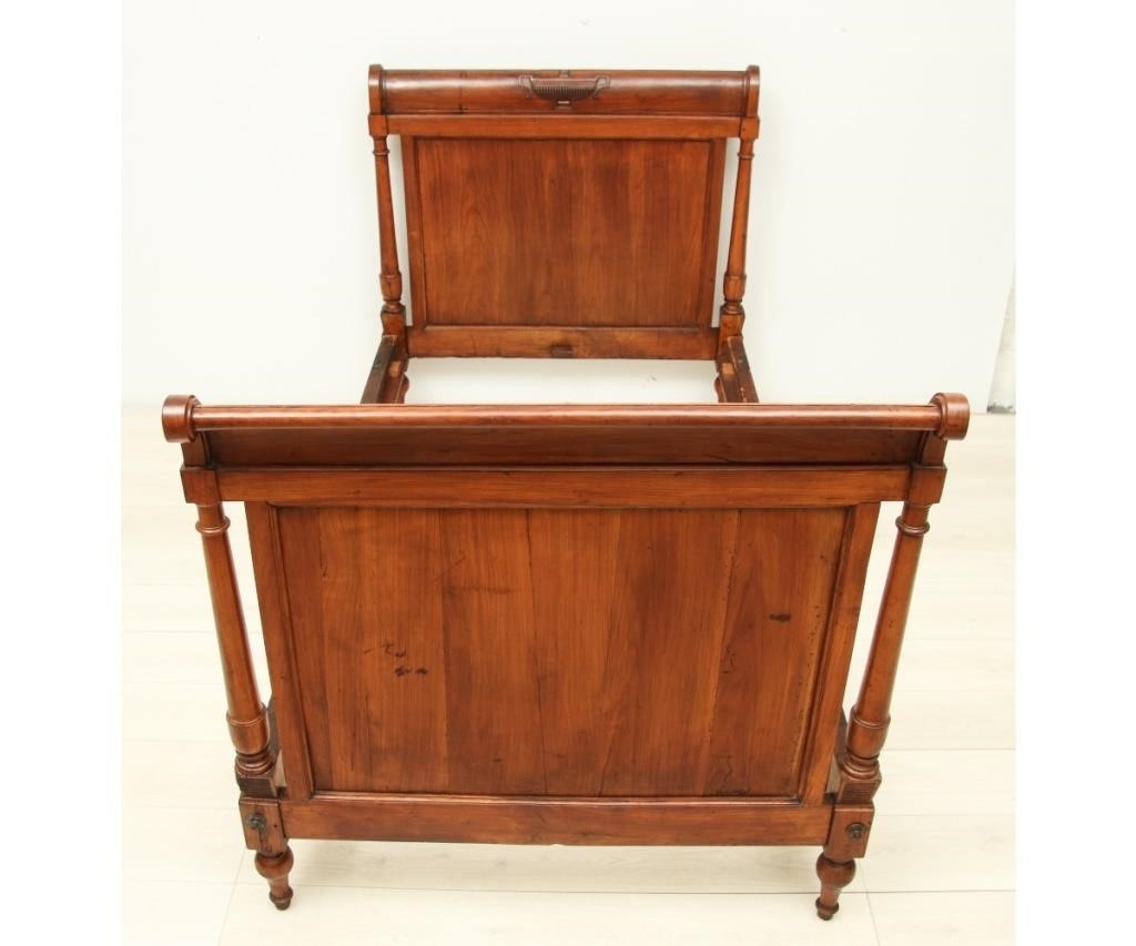 Appraisal: French walnut single bed with relief-carved urns th c h