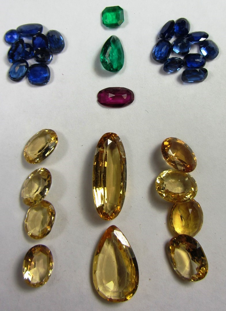 Appraisal: A collection of unmounted gemstones comprising sapphires emeralds a red