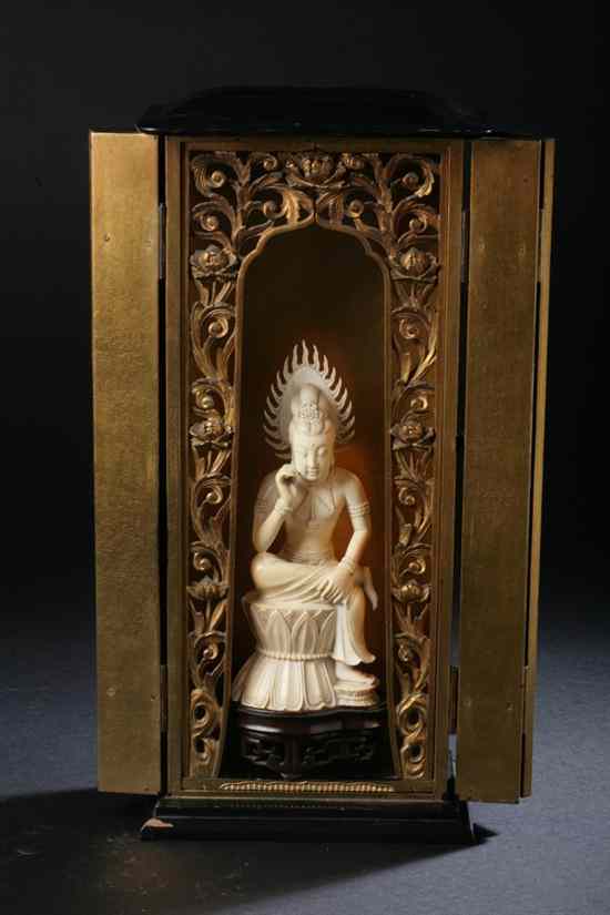 Appraisal: JAPANESE IVORY FIGURE OF DEITY Seated in lacquered shrine -