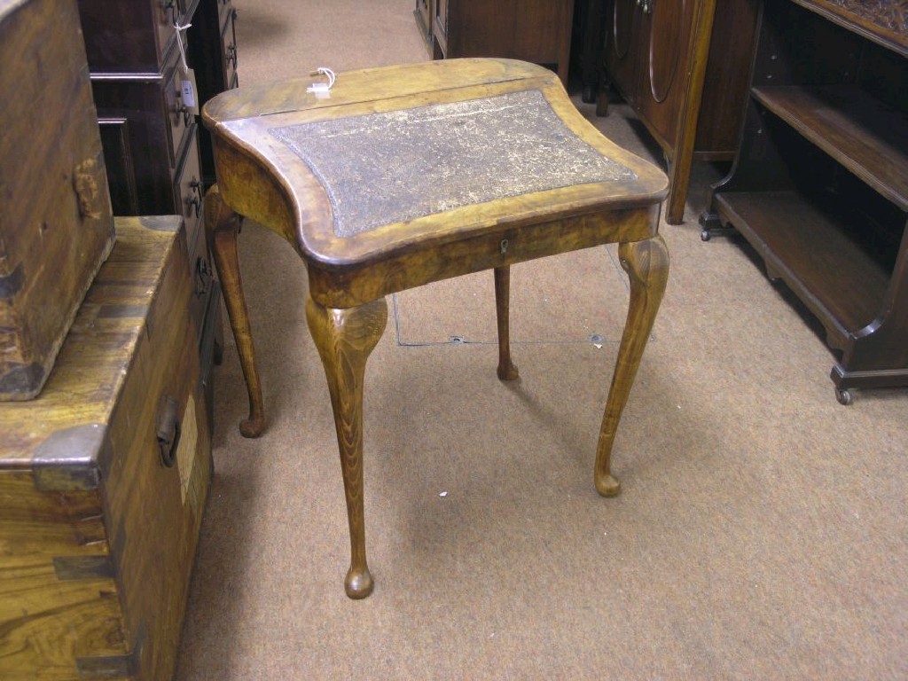 Appraisal: A child-size writing table modified burr walnut with sloping hinged