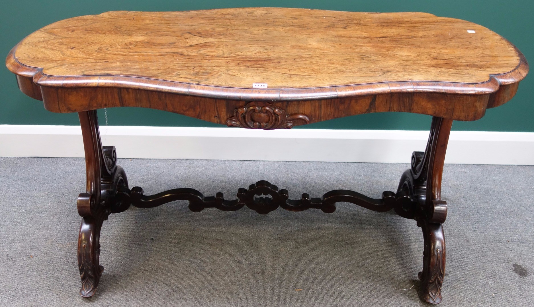 Appraisal: A Victorian rosewood centre table with shaped top over a