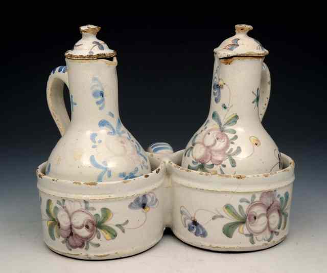 Appraisal: A FAIENCE POLYCHROME POTTERY CRUET with two oil and vinegar