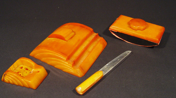 Appraisal: Art Deco Carvacraft amber plastic inkwell ashtray and paper knife