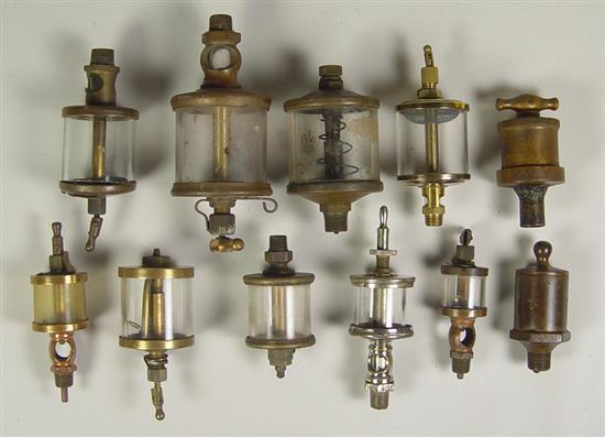 Appraisal: Eleven Small Brass Glass Oilers Early 's Antique engine oilers