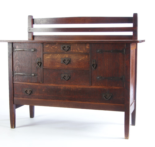 Appraisal: GUSTAV STICKLEY Strap-hinge sideboard no with three central drawers flanked