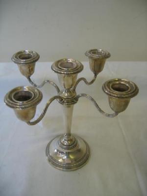 Appraisal: A FIVE LIGHT CANDELABRUM the urn shaped sconces with foliate