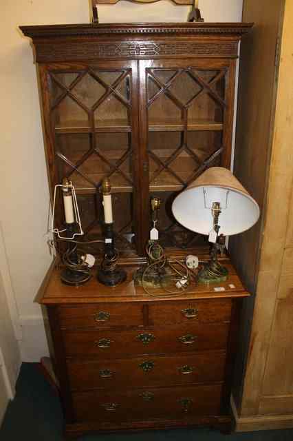 Appraisal: A SMALL OAK TWO TIER BOOKCASE the upper section enclosed