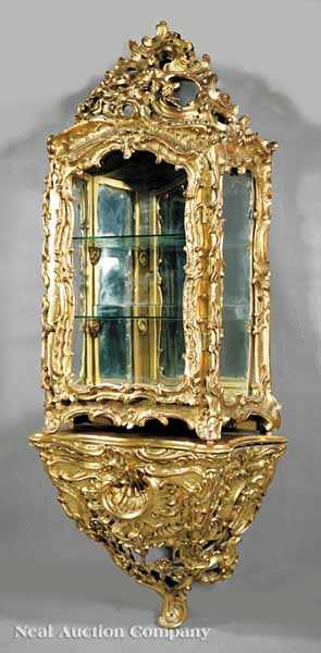 Appraisal: A Beaux Arts Carved and Giltwood Vitrine with Bracket in