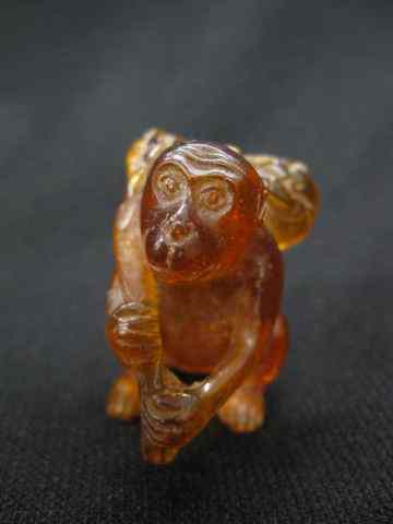 Appraisal: Amber Netsuke of a Monkey fruit over hisshoulder - ''