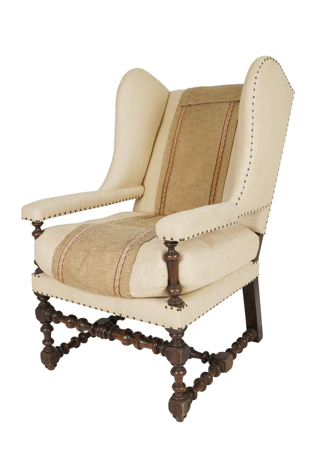 Appraisal: JACOBEAN STYLE WALNUT WING CHAIRwith linen and woven runner upholstery