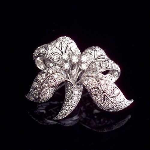 Appraisal: DIAMOND Orchid brooch in k white gold Delicate filigree flower