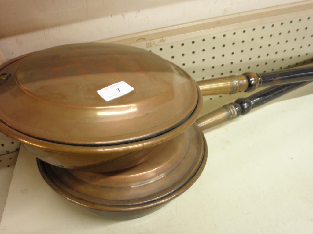 Appraisal: Two Victorian copper warming pans with turned wood handles