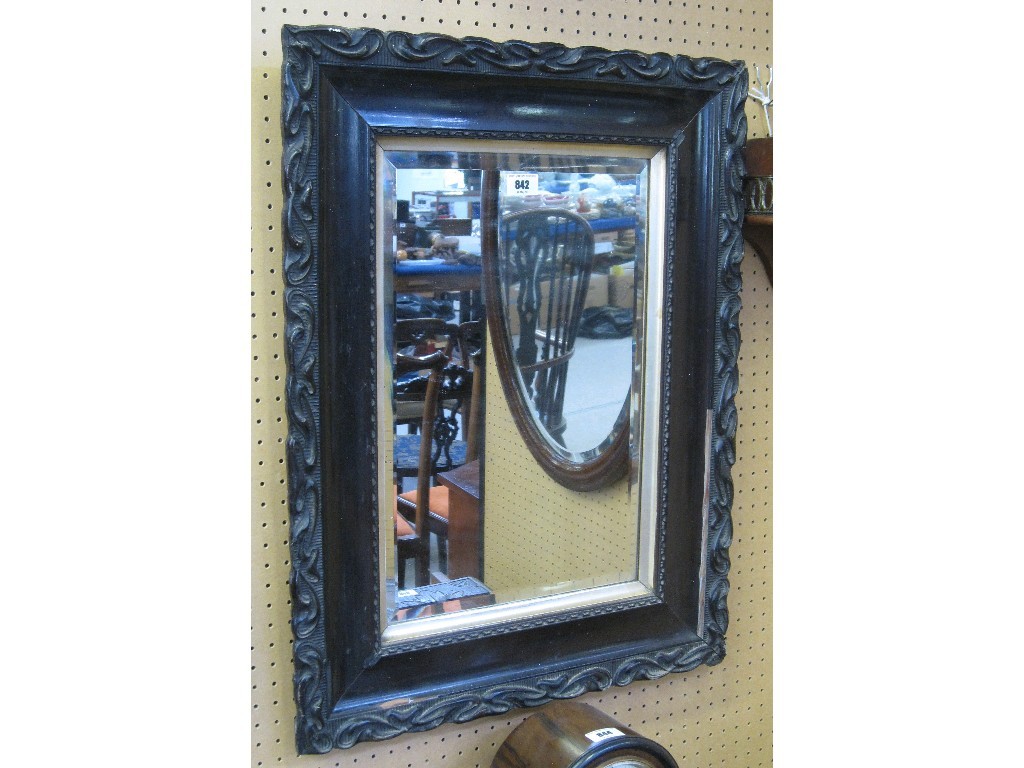 Appraisal: Carved and ebonised wall mirror