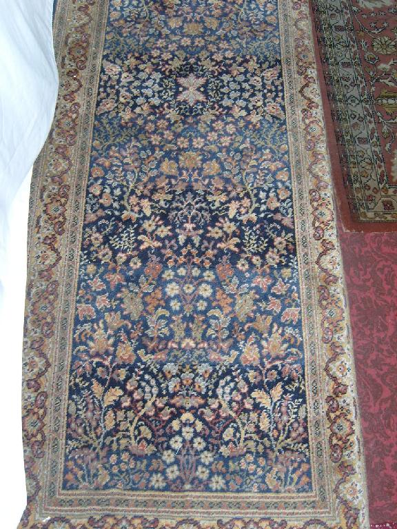 Appraisal: A blue ground wool runner with stylised floral decoration in