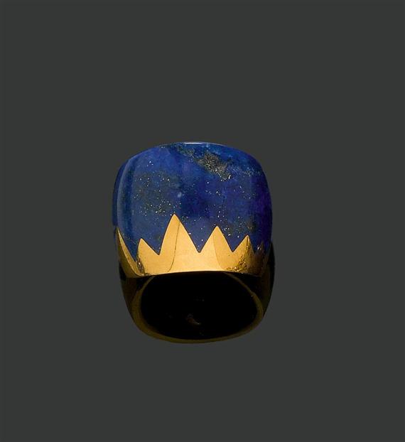 Appraisal: LAPIS LAZULI AND GOLD RING Yellow gold Wide convex band