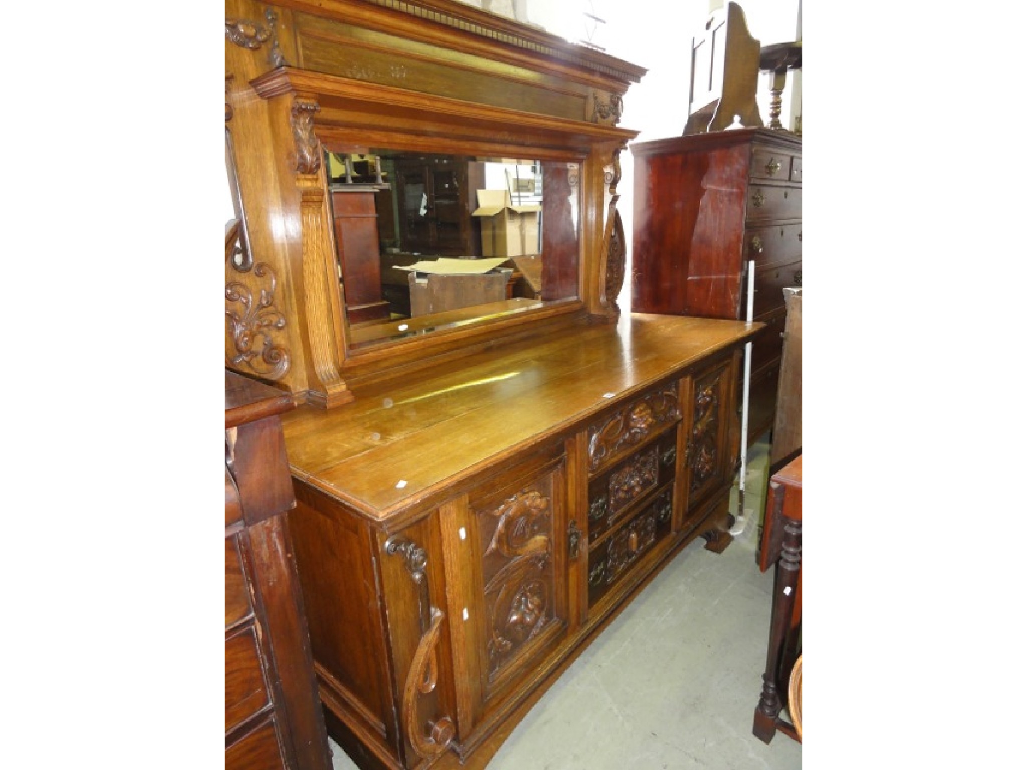 Appraisal: A large arts and crafts style oak mirror back sideboard