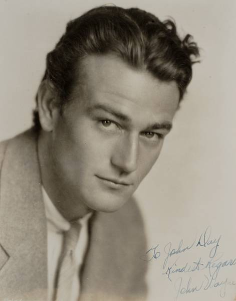 Appraisal: A John Wayne signed black and white photograph s A