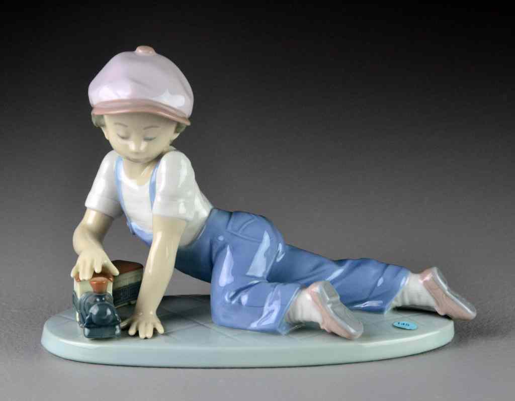 Appraisal: Lladro Porcelain Figurine ''All Aboard''''Todos al Tren'' depicting a boy