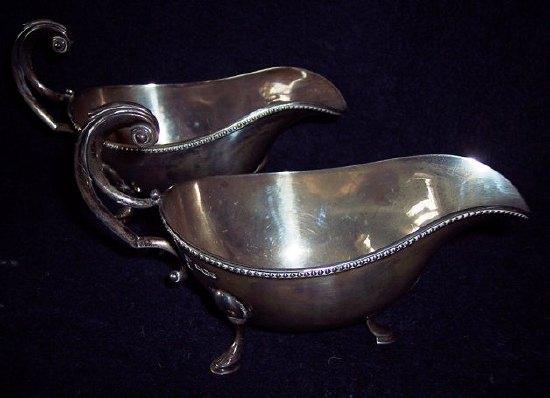 Appraisal: A pair of sauceboats with beaded rims and scroll handles