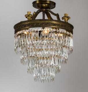 Appraisal: Hollywood Regency style four-tier crystal chandelier the gilt metal canopy