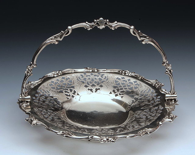 Appraisal: A VICTORIAN SILVER SWING HANDLED CAKE BASKET by Henry Wilkinson