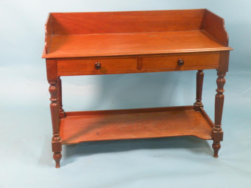 Appraisal: An early Victorian mahogany washstand with a raised back above