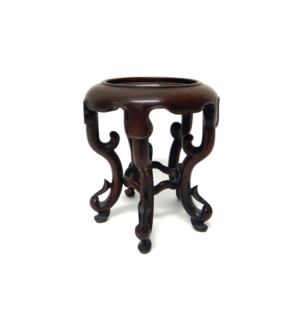 Appraisal: A Chinese hardwood vase stand with circular dished top shaped