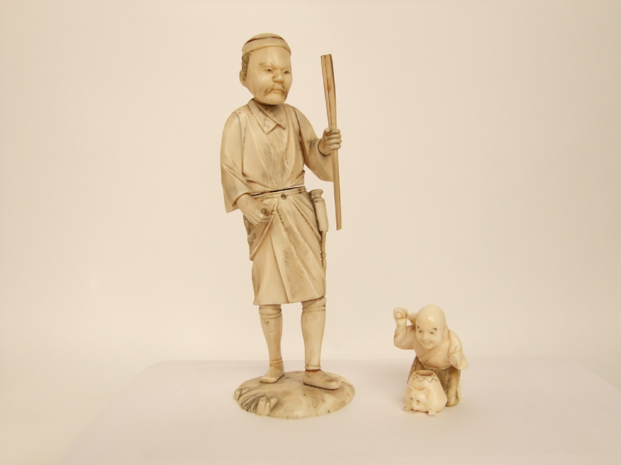 Appraisal: Two late th early th century Japanese ivory figures male